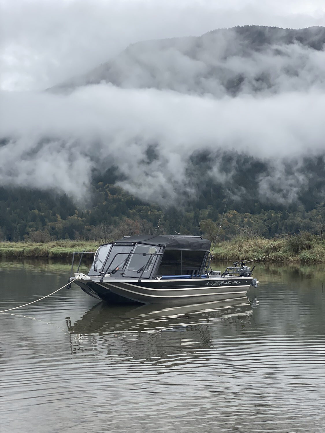 Misty mountain with Hell's Canyon jet boat in the foreground.