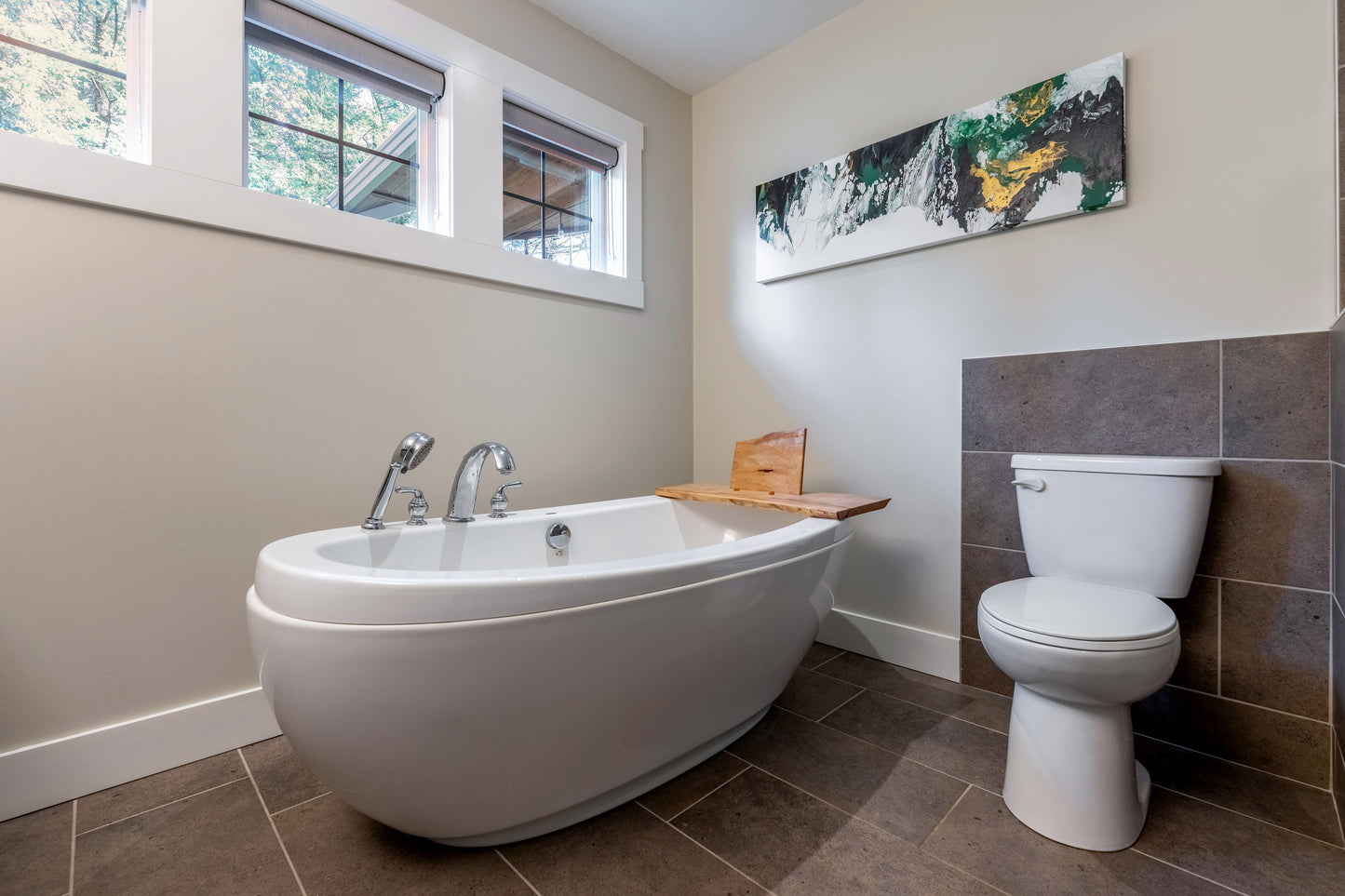 Wide angle view of ensuite tub and toilet.