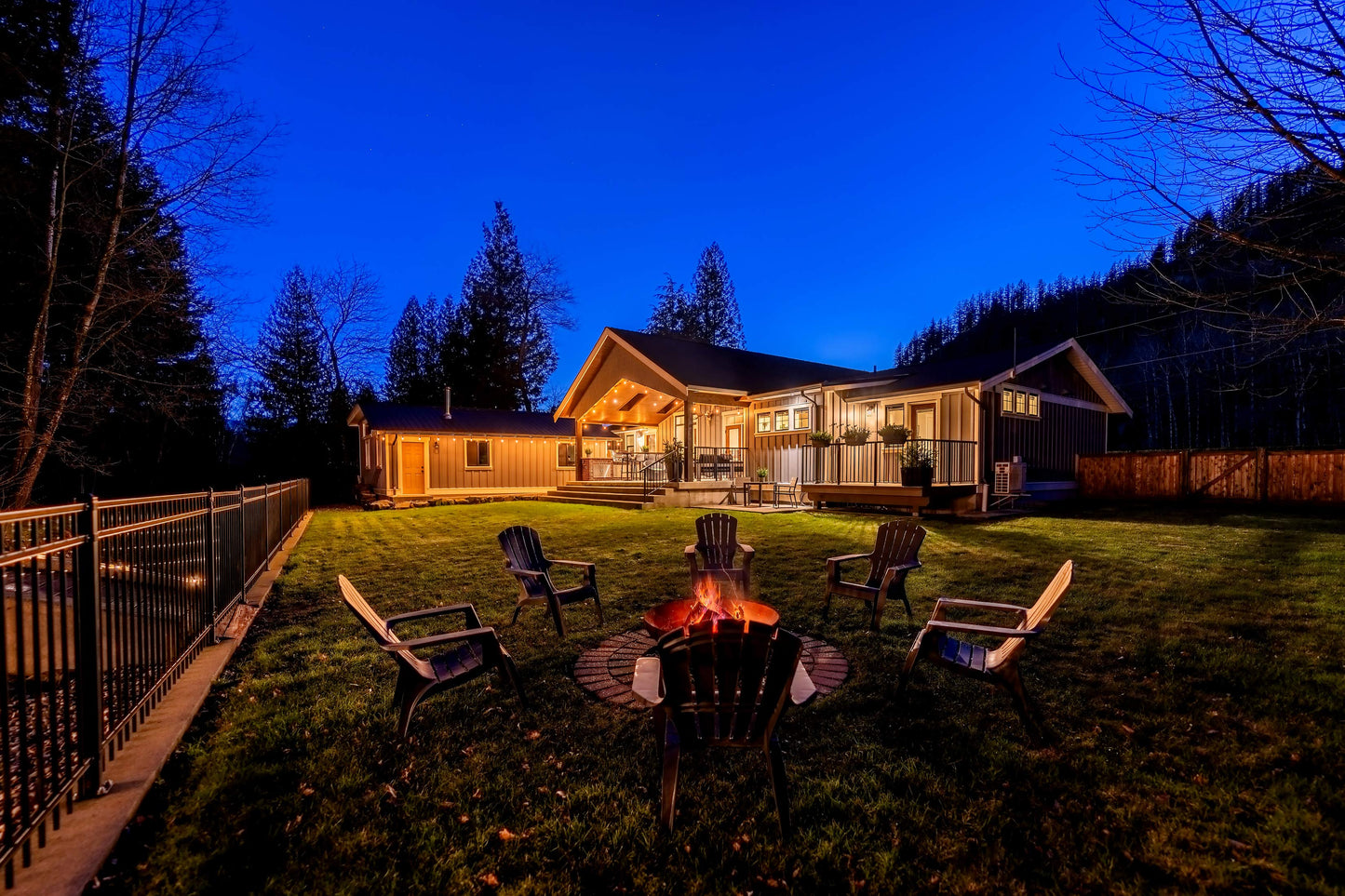 Wide angle view of the backyard, patio and fire pit at night. 