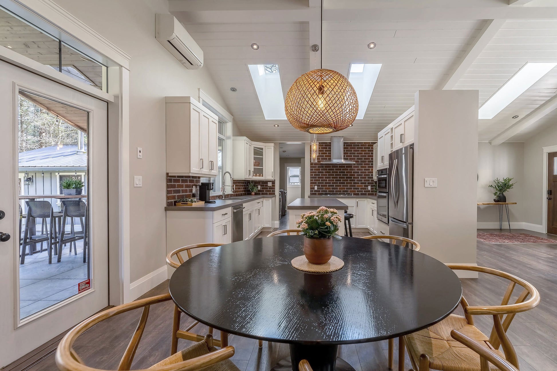 Wide angle view of the dining table and kitchen. 