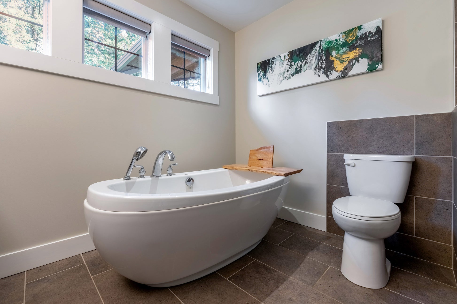Wide angle view of ensuite tub and toilet.  
